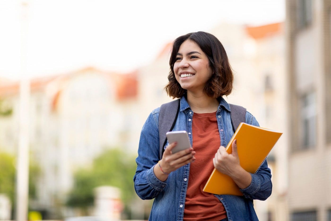 student on phone on campus