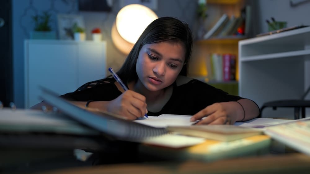 Student working on an essay for NYU