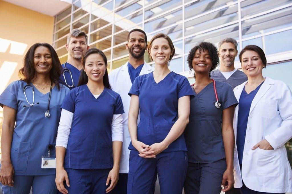Medical interns standing outside of hospital